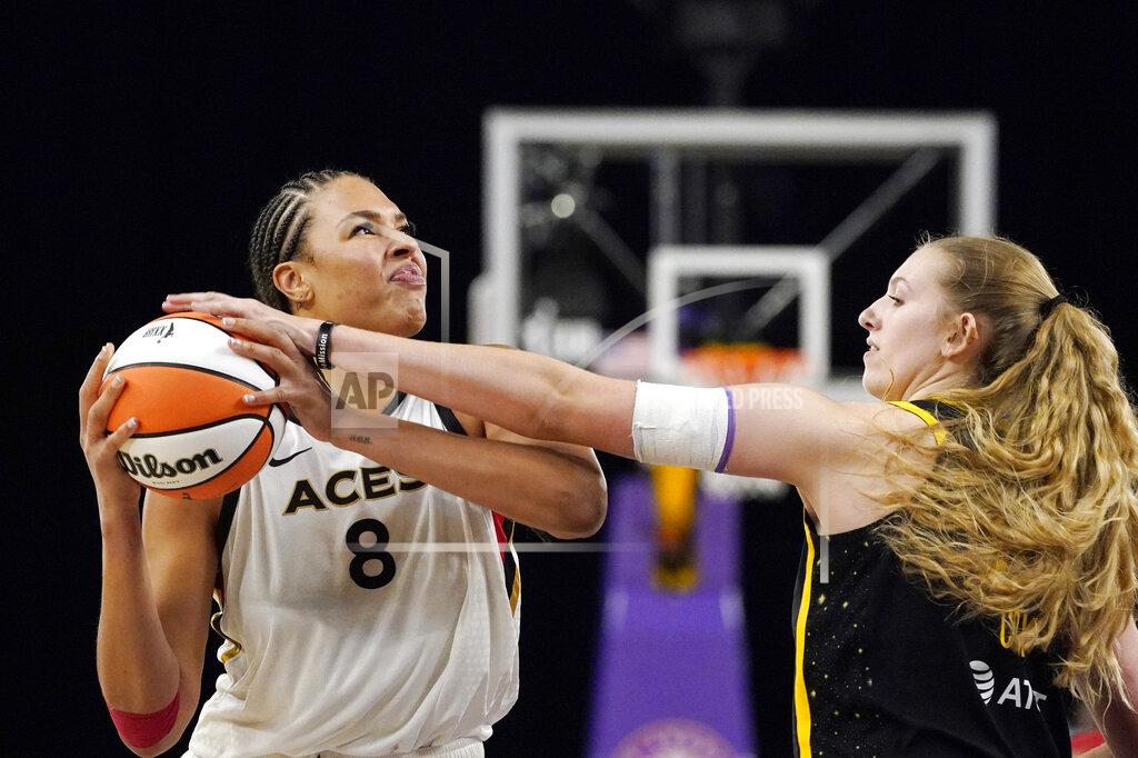 Mark J. Terrill Las Vegas Aces center Liz Cambage, left, tries to shoot as Los Angeles Sparks forward Lauren Cox defends during the second half of a WNBA basketball game Friday, July 2, 2021, in Los Angeles. The Aces won 66-58. (AP Photo/Mark J. Terrill)