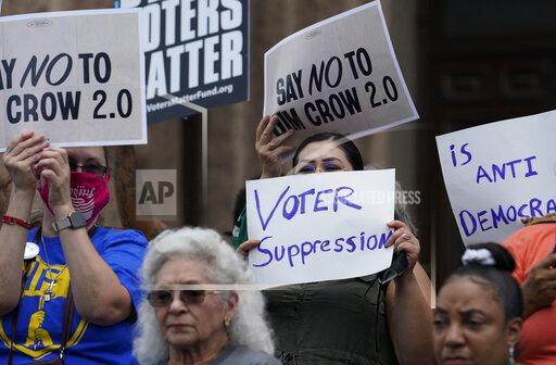 FILE - Demonstrators join a rally to protest proposed voting bills on the steps of the Texas Capitol on July 13, 2021, in Austin, Texas. A sweeping new Texas voting law that Republicans muscled through the Legislature last year over dramatic protests is drawing fire again, even before some of the most contentious restrictions and changes kick in ahead of the state's first-in-the nation primary. (AP Photo/Eric Gay, File)