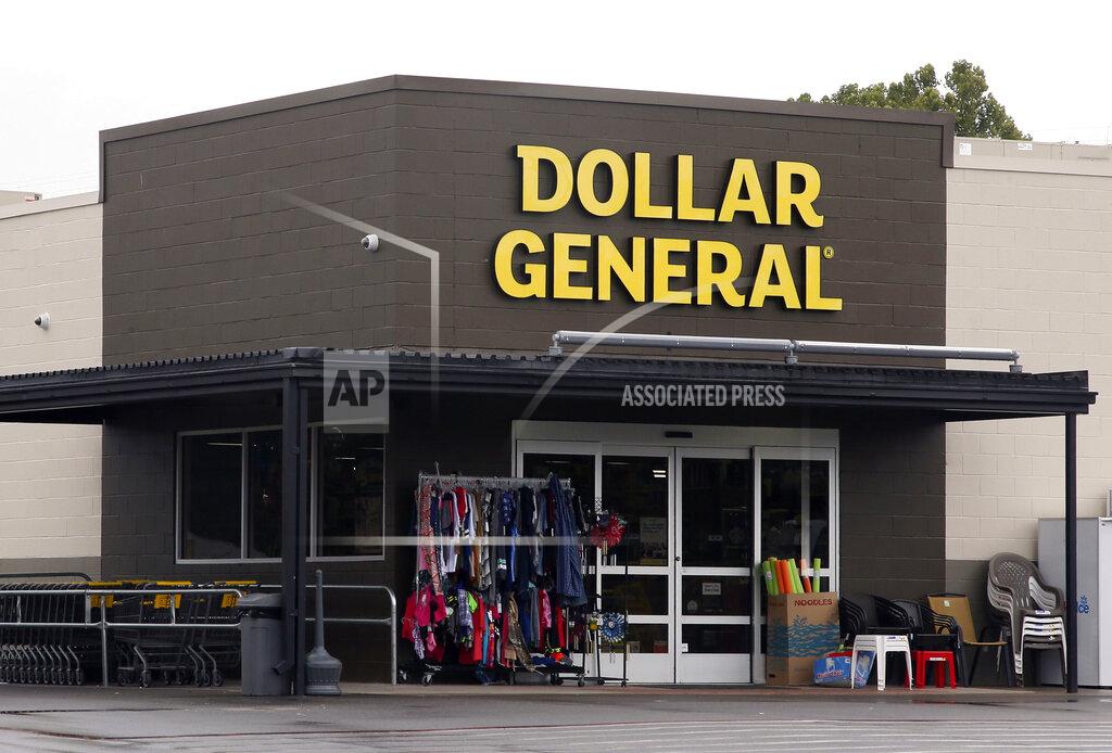FILE- In this Aug. 3, 2017, file photo the Dollar General store is pictured in Luther, Okla. As vaccinations continue across the U.S., some companies are offering financial incentives to encourage their workers to get the shots. Dollar General is one of the first major companies to announce extra pay for workers who get vaccinated. The Tennessee-based retailer said Wednesday, Jan. 13, 2021 it will give employees the equivalent of four hours of pay if they get the vaccine. (AP Photo/Sue Ogrocki, File)
