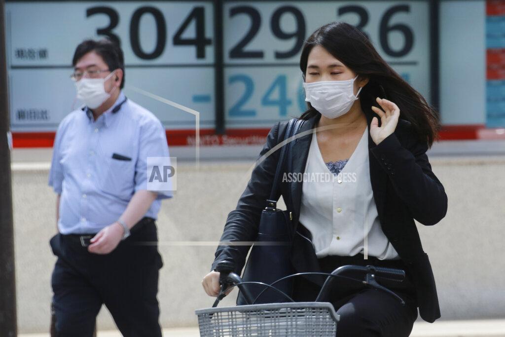 Koji Sasahara People walk by an electronic stock board of a securities firm in Tokyo, Wednesday, Sept. 15, 2021. Asian stock markets followed Wall Street down on Wednesday after U.S. inflation was lower than expected amid unease about the impact of the spread of the coronavirus's delta variant. (AP Photo/Koji Sasahara)