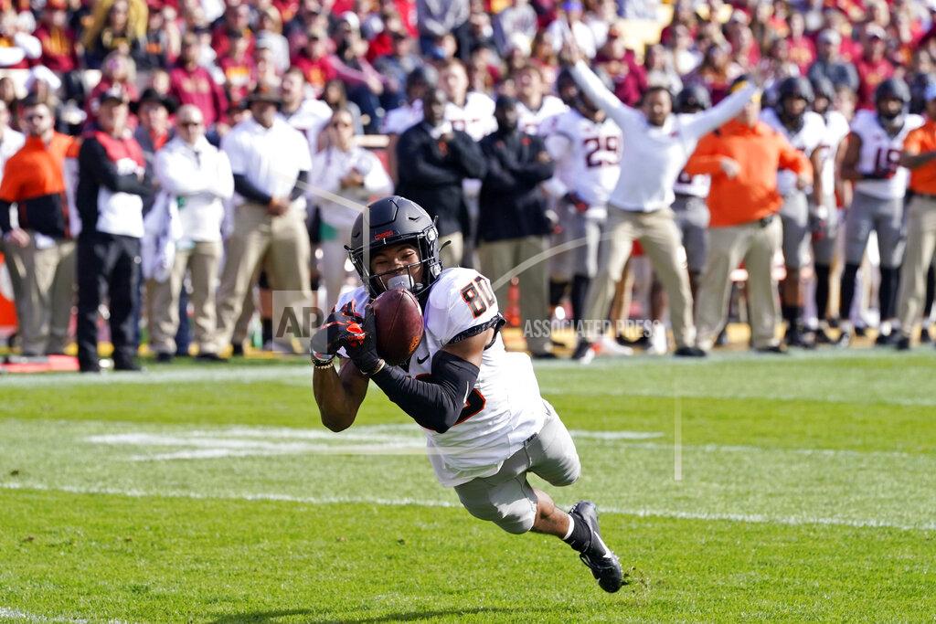 Charlie Neibergall Oklahoma State wide receiver Brennan Presley (80) catches a 5-yard touchdown pass during the first half of an NCAA college football game against Iowa State, Saturday, Oct. 23, 2021, in Ames, Iowa. (AP Photo/Charlie Neibergall)