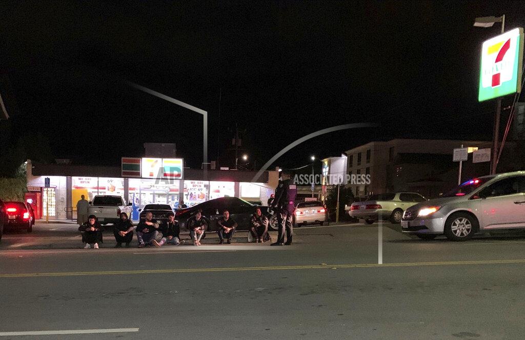 Uncredited This Friday, April 10, 2020, photo released by the Santa Cruz Police Department shows several visitors from Fremont, Calif., who were hanging out at a 7-11 store on Ocean Street in Santa Cruz, Calif. Those that didn't comply with stay-at-home orders risked substantial fines. The visitors were each slapped with $1,000 fines for gathering outside a 7-Eleven store Friday night. (Santa Cruz Police Department via AP)