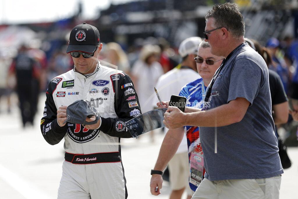 Gerry Broome Kevin Harvick signs autographs during practice for Sunday's NASCAR Cup Series auto race at Charlotte Motor Speedway in Concord, N.C., Saturday, Sept. 28, 2019. (AP Photo/Gerry Broome)