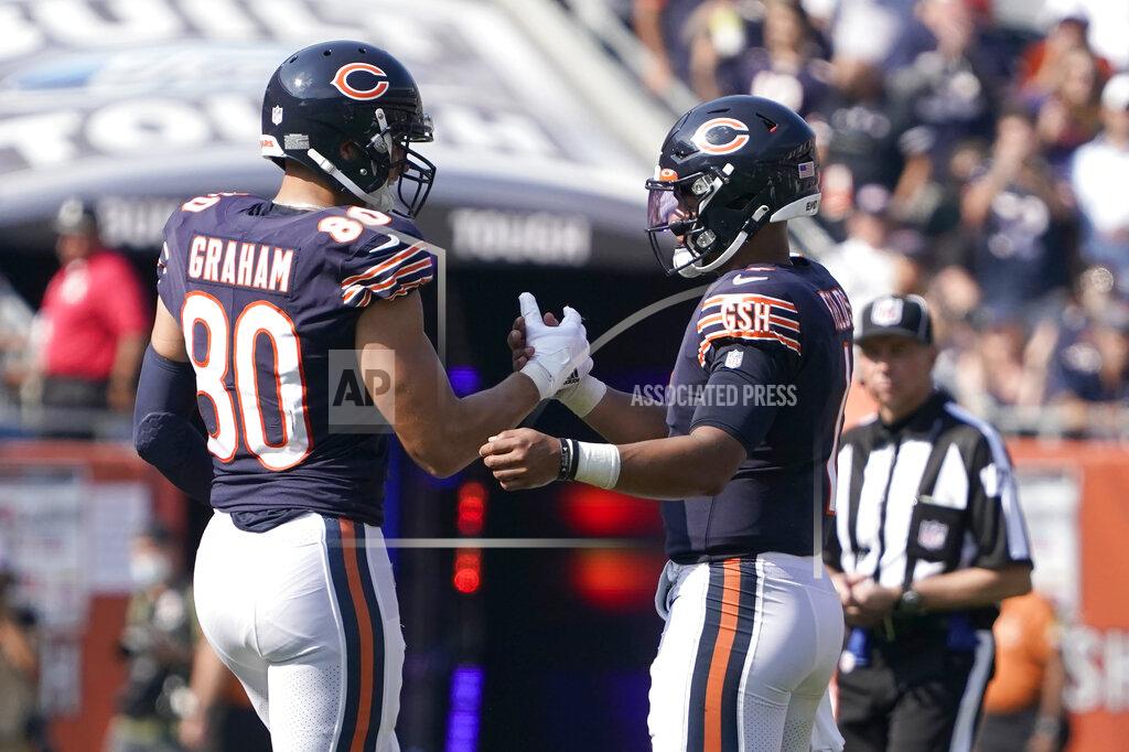 Chicago Bears tight end Jimmy Graham (80) celebrates with quarterback Justin Fields the team's 20-17 win over the Cincinnati Bengals after an NFL football game Sunday, Sept. 19, 2021, in Chicago. (AP Photo/David Banks)