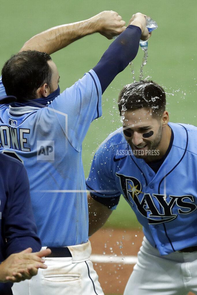 Chris O'meara CORRECTS TO TRIPLE, INSTEAD OF DOUBLE - Tampa Bay Rays' Kevin Kiermaier, right, gets water poured on him by Brandon Lowe after Kiermaier hit a walk-off two-run triple off Toronto Blue Jays relief pitcher Shun Yamaguchi during the 10th inning of a baseball game Sunday, July 26, 2020, in St. Petersburg, Fla. The Rays won 6-5. (AP Photo/Chris O'Meara)