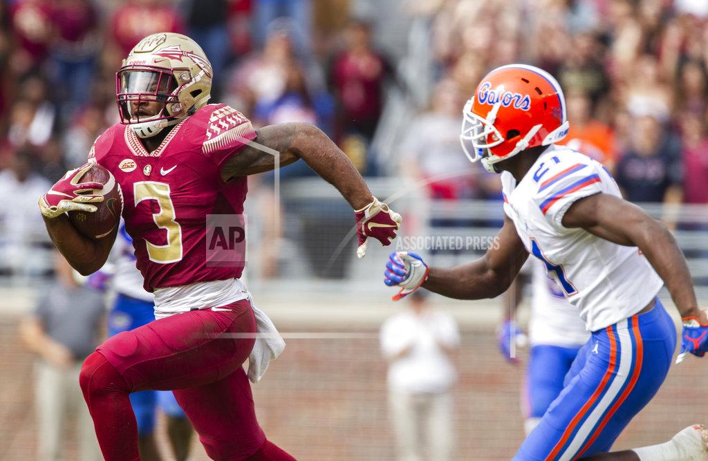 Mark Wallheiser Florida State running back Cam Akers (3) makes a long reception and run past Florida defensive back Trey Dean III (21) in the 1st half of an NCAA college football game in Tallahassee, Fla., Saturday, Nov. 24, 2018. (AP Photo/Mark Wallheiser)