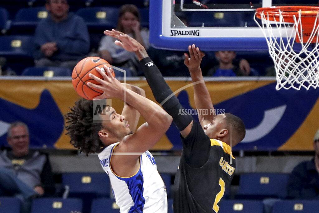 Keith Srakocic Pittsburgh's Justin Champagnie, left, shots as Arkansas-Pine Bluff's Marquell Carter (2) defends during the first half of an NCAA college basketball game Thursday, Nov. 21, 2019, in Pittsburgh. (AP Photo/Keith Srakocic)