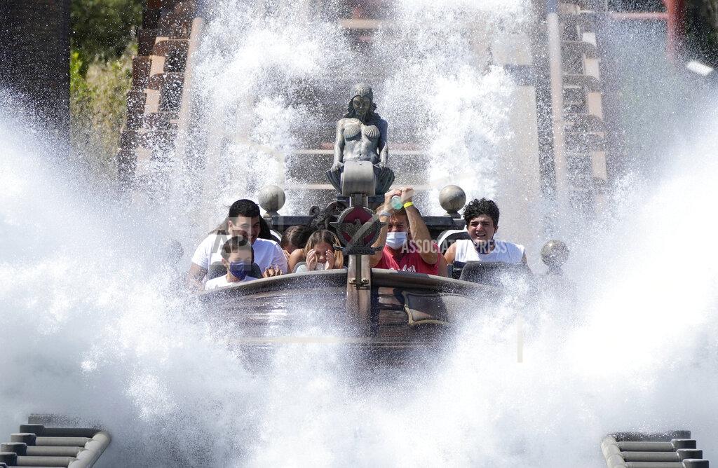 Alessandra Tarantino Visitors ride a roller coaster at Cinecitta World amusement park in the outskirts of Rome in the day of its reopening, Thursday, June 17, 2021. Amusement parks have been closed since Oct. 25 2020, when Italy's second national lockdown started. (AP Photo/Alessandra Tarantino)
