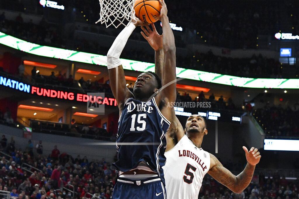 Timothy D. Easley Louisville forward Malik Williams (5) attempts to block the shot of Duke center Mark Williams (15) during the first half of an NCAA college basketball game in Louisville, Ky., Saturday, Jan. 29, 2022. (AP Photo/Timothy D. Easley)