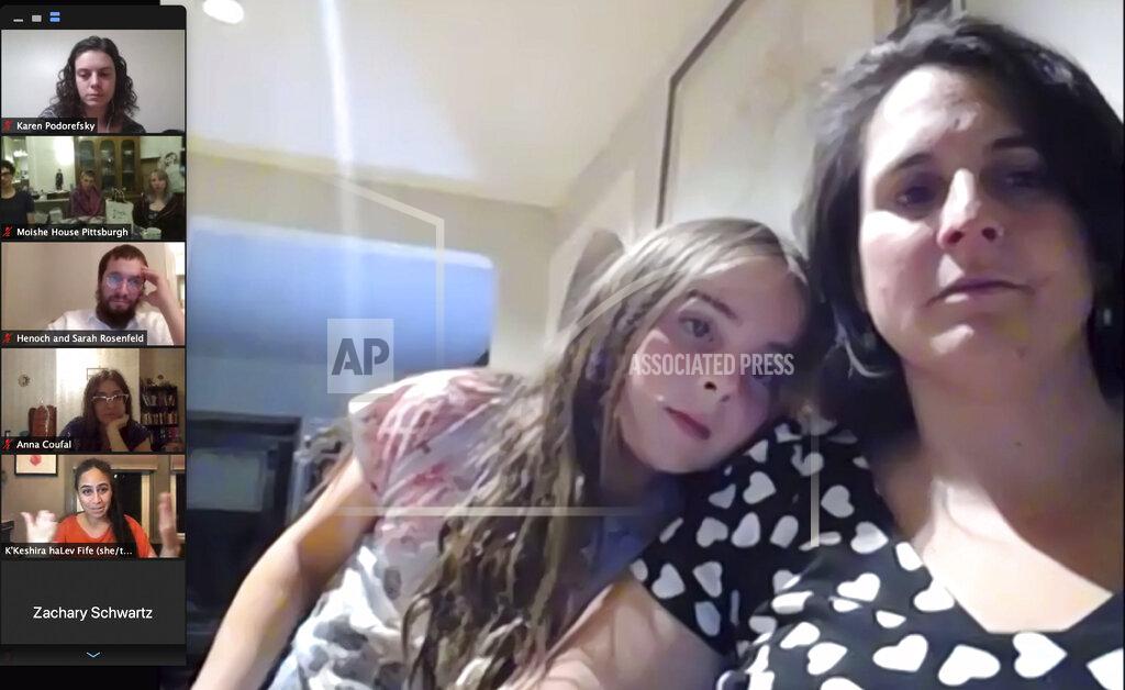 Jessie Wardarski In this Oct. 22, 2020 image from a video conference, Maggie Feinstein and her daughter attend a virtual roundtable with 37 community members to commemorate and reflect on the 2018 mass shooting at the Tree of Life synagogue in Pittsburgh. Tuesday, Oct. 27, 2020, marks two years since 11 people were killed while worshipping at the synagogue. (AP Photo)