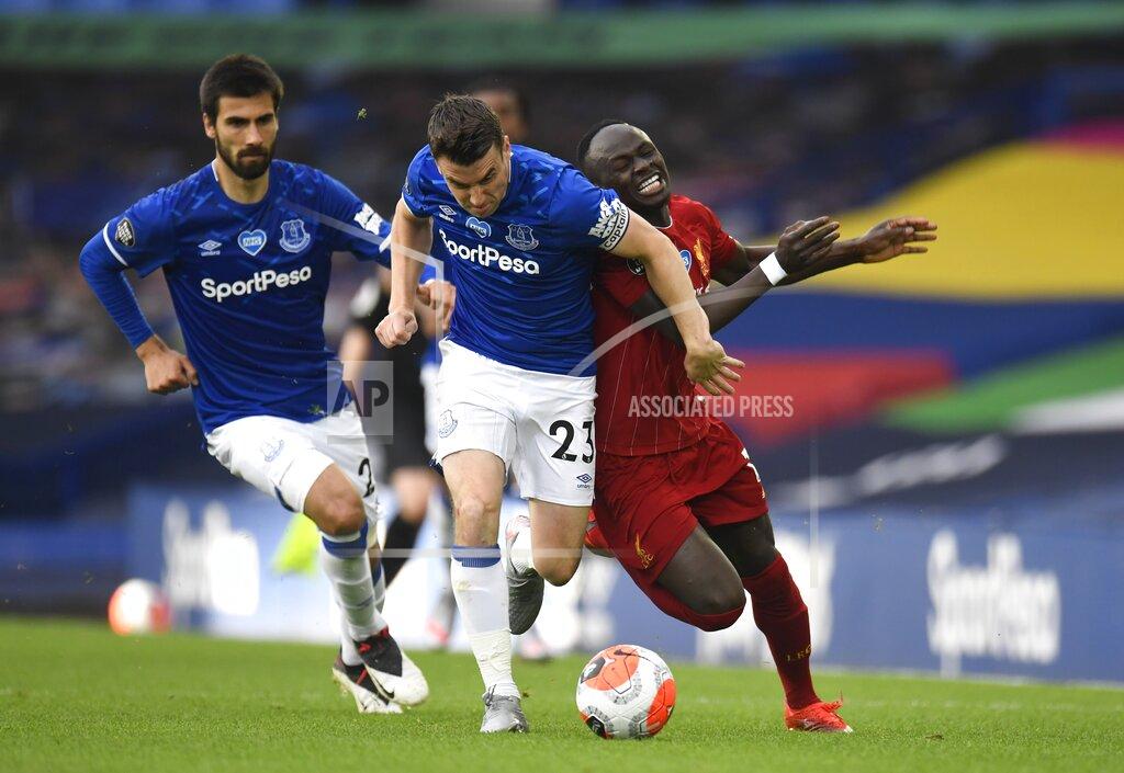 Peter Powell Everton's Seamus Coleman, left, challenges Liverpool's Sadio Mane during the English Premier League soccer match between Everton and Liverpool at Goodison Park in Liverpool, England, Sunday, June 21, 2020. (Peter Powell/Pool via AP)