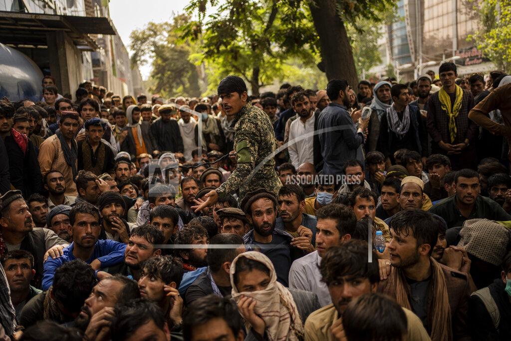 Bernat Armangue Afghans wait in front of a bank branch as they try to withdraw money in Kabul, Afghanistan, Sunday, Sept. 12, 2021. (AP Photo/Bernat Armangue)