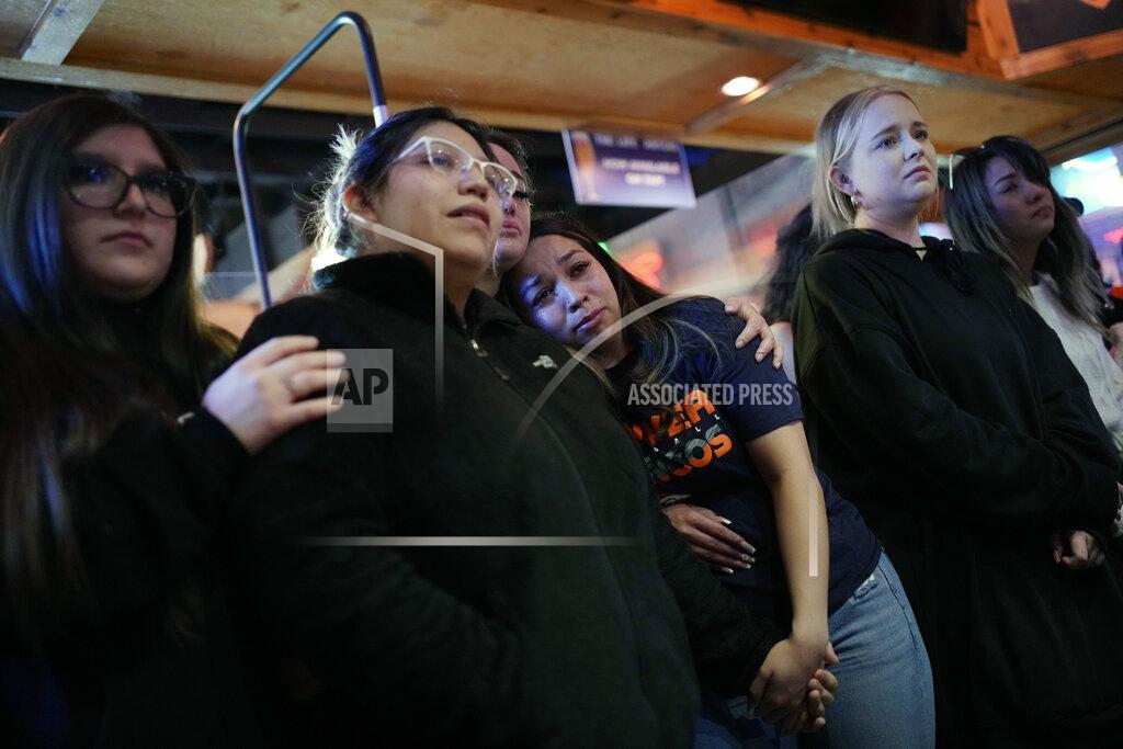 John Locher Bryanna Saiz, center, cries with others during a memorial for Jackson Zinn at a Texas Roadhouse restaurant, Thursday, March 17, 2022, in Hobbs, New Mexico. Zinn, who worked at the restaurant, was killed with several other student golfers and the coach of University of the Southwest in a crash in Texas. (AP Photo/John Locher)