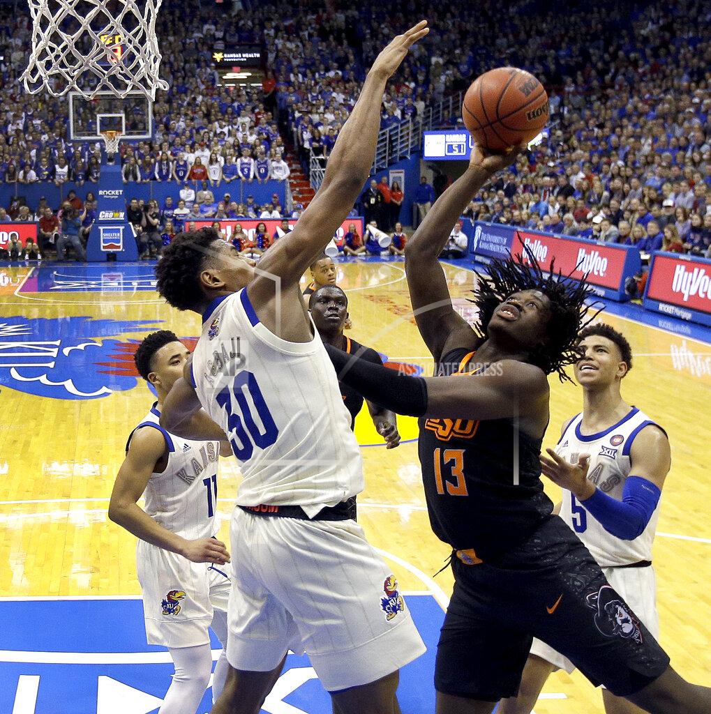 Charlie Riedel Kansas' Ochai Agbaji (30) blocks a shot by Oklahoma State's Isaac Likekele (13) during the second half of an NCAA college basketball game Saturday, Feb. 9, 2019, in Lawrence, Kan. Kansas won 84-72. (AP Photo/Charlie Riedel)