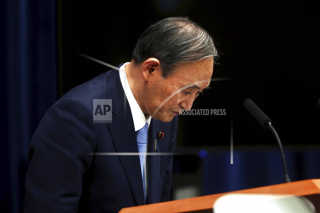 Japan's Prime Minister Yoshihide Suga bows after a press conference at the prime minister's official residence Friday, May 28, 2021, in Tokyo. Japan extended a coronavirus state of emergency in Tokyo and other areas for 20 more days on Friday, with infections still not slowing as it prepares to host the Olympics in just over 50 days. (Behrouz Mehri/Pool Photo via AP)