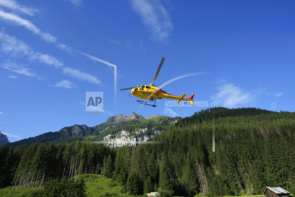Luca Bruno A rescue helicopter takes off to conduct searches for the victims of the Punta Rocca glacier avalanche in Canazei, in the Italian Alps in northern Italy, Tuesday, July 5, 2022, two day after a huge chunk of the glacier broke loose, sending an avalanche of ice, snow, and rocks onto hikers. (AP Photo/Luca Bruno)
