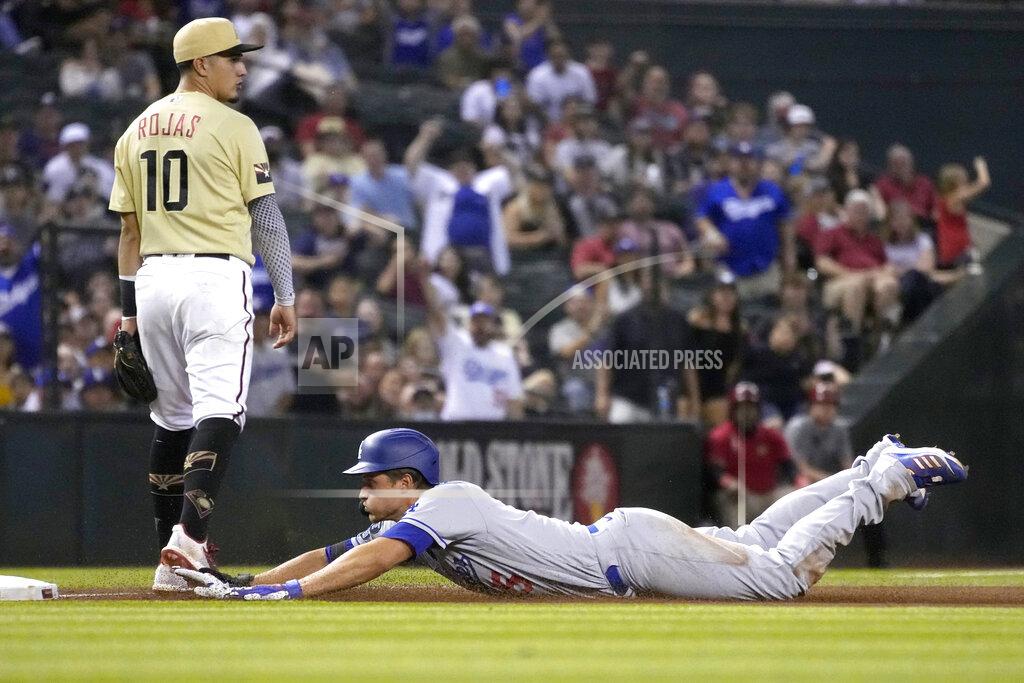 Rick Scuteri Los Angeles Dodgers shortstop Corey Seager dives into third base in front of Arizona Diamondbacks third baseman Josh Rojas (10)after hitting a triple in the seventh inning during a baseball game, Friday, Sept. 24, 2021, in Phoenix. (AP Photo/Rick Scuteri)