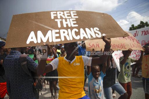 People protest for the release of kidnapped missionaries near the Ohio-based Christian Aid Ministries headquarters in Titanyen, north of Port-au-Prince, Haiti, Tuesday, Oct. 19, 2021. A group of 17 U.S. missionaries including children was kidnapped by a gang in Haiti on Saturday, Oct. 16, according to a voice message sent to various religious missions by an organization with direct knowledge of the incident. (AP Photo/Joseph Odelyn)