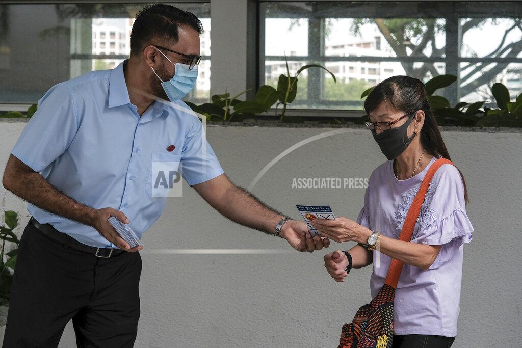 Royston Toh Workers' Party Secretary-General Pritam Singh gives a pamphlet to a woman outside the MRT station in Hougang during the final day of the election campaign Wednesday, July 8, 2020, in Singapore. Singaporeans go to the polls on July 10 in Southeast Asia's first election since the coronavirus pandemic began, with the health crisis and an economic recession expected to bolster Prime Minister Lee Hsien Loong's party and extend its unbroken rule. (AP Photo/Ee Ming Toh)