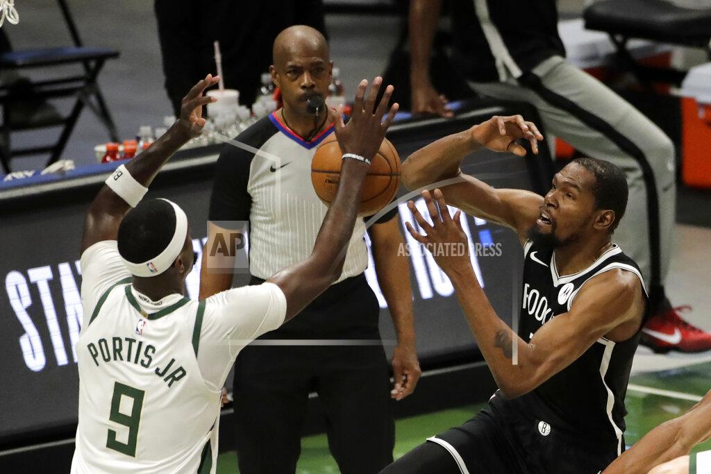 Aaron Gash Brooklyn Nets' Kevin Durant is fouled as he shoots against Milwaukee Bucks' Bobby Portis (9) during the first half of an NBA basketball game Tuesday, May 4, 2021, in Milwaukee. (AP Photo/Aaron Gash)