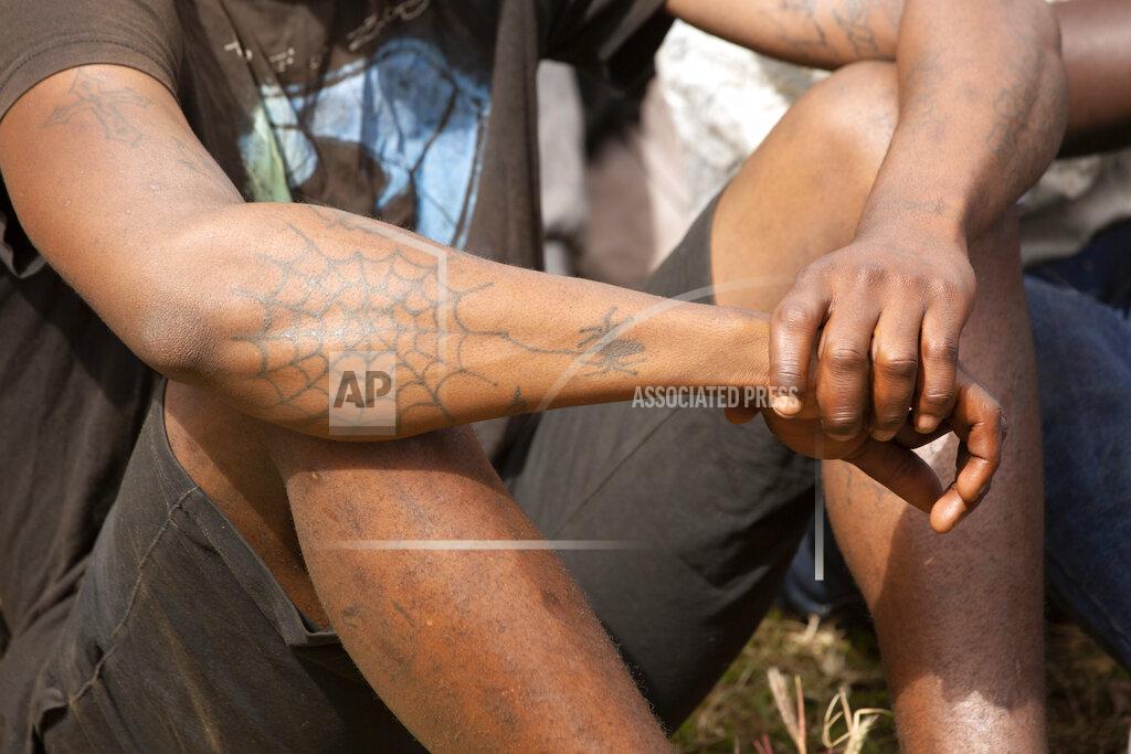 Tsvangirayi Mukwazhi Prisoners are briefed about the dangers of the coronavirus following their release from Chikurubi prison on the outskirts of Harare, Saturday, April 17, 2021. Zimbabwe began the release of about 3,000 prisoners under a presidential amnesty aimed at easing congestion and minimizing the threat of COVID-19 across the country's overcrowded jails. (AP Photo/Tsvangirayi Mukwazhi)