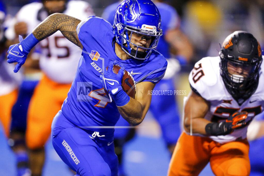 Steve Conner Boise State running back Cyrus Habibi-Likio (4) turns the corner against Oklahoma State linebacker Malcolm Rodriguez (20) for a 5-yard touchdown run during the first half of an NCAA college football game Saturday, Sept. 18, 2021, in Boise, Idaho. (AP Photo/Steve Conner)