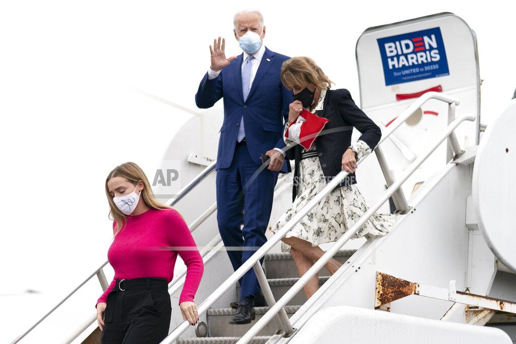 Andrew Harnik Democratic presidential candidate former Vice President Joe Biden arrives with his granddaughter Finnegan Biden, left, and sister Valerie Biden, right, at Columbus Airport in Columbus, Ga., Tuesday, Oct. 27, 2020, to travel to Warm Springs, Ga. for a rally. (AP Photo/Andrew Harnik)