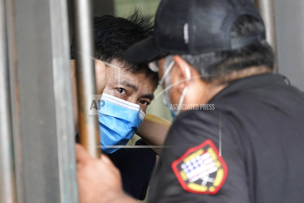 David J. Phillip A security guard, right, talks with a man inside the Chinese Consulate Thursday, July 23, 2020, in Houston. China says “malicious slander" is behind an order by the U.S. government to close its consulate in Houston, and maintains that its officials have never operated outside ordinary diplomatic norms. (AP Photo/David J. Phillip)
