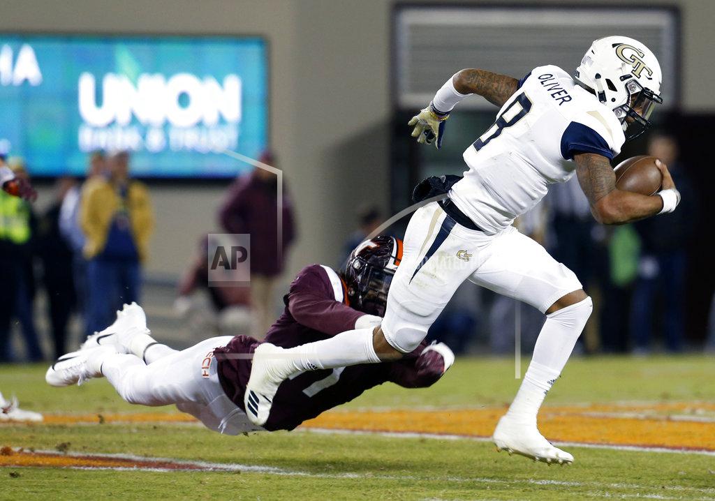 Steve Helber Georgia Tech quarterback Tobias Oliver (8) tries to break the tackle of Virginia Tech defensive lineman Houshun Gaines (11) during the first half of an NCAA college football game in Blacksburg, Va., Thursday, Oct. 25, 2018. (AP Photo/Steve Helber)