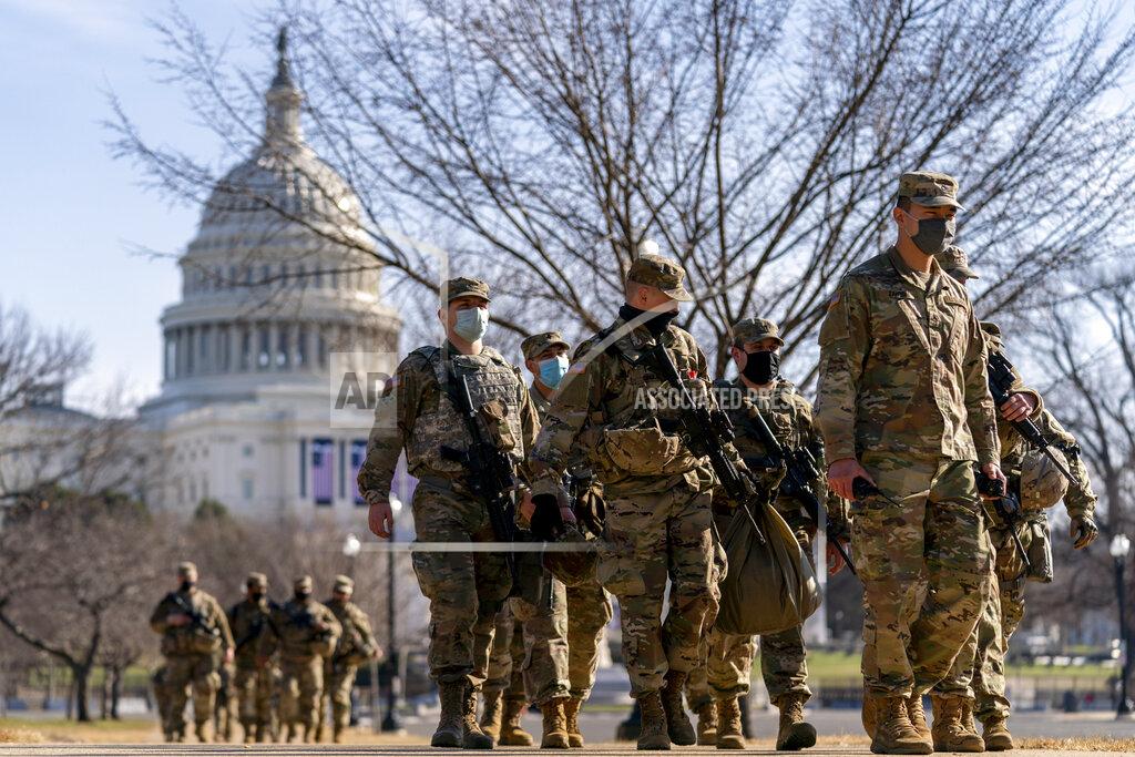 Andrew Harnik Members of the National Guard patrol outside the Capitol Building on Capitol Hill in Washington, Thursday, Jan. 14, 2021. (AP Photo/Andrew Harnik)