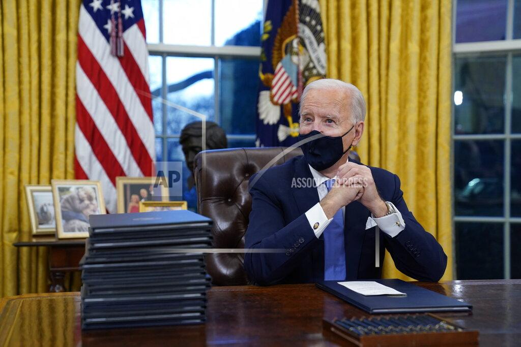 Evan Vucci FILE - In this Jan. 20, 2021, file photo President Joe Biden waits to sign his first executive order in the Oval Office of the White House in Washington. As one of his first acts, Biden offered a sweeping immigration overhaul that would provide a path to U.S. citizenship for the estimated 11 million people who are in the United States illegally. It would also codify provisions wiping out some of President Donald Trump's signature hard-line policies, including trying to end existing, protected legal status for many immigrants brought to the U.S. as children and crackdowns on asylum rules. (AP Photo/Evan Vucci, File)