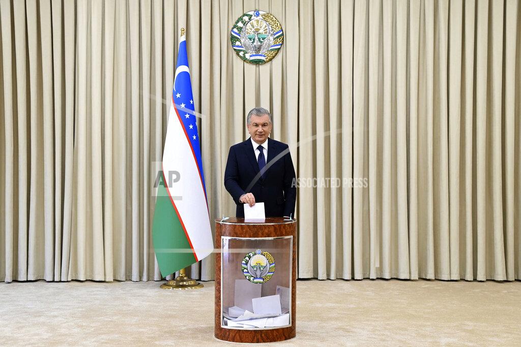 Uncredited Uzbek President Shavkat Mirziyoyev casts his ballot at a polling station during the presidential election in Tashkent, Uzbekistan, Sunday, Oct. 24, 2021. Uzbeks voted Sunday in a presidential election that the incumbent is expected to win in a landslide against weak competition. Although Shavkat Mirziyoyev has relaxed many of the policies of his dictatorial predecessor, he has made little effort at political reform. He took office in 2016 upon the death of Islam Karimov and faces four relatively low-visibility candidates who did not even show up for televised debates. (Uzbekistan Presidential Press Service Pool photo via AP)