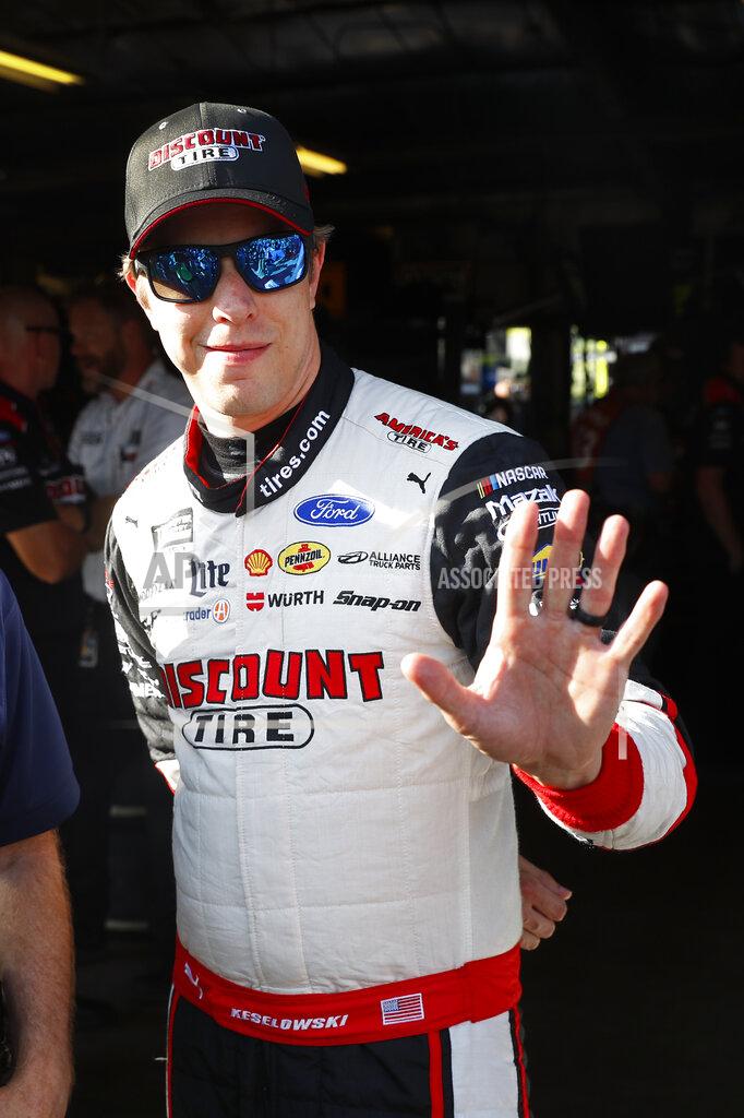 Paul Sancya Brad Keselowski waves after winning the pole during qualifying for the NASCAR Cup Series auto race at Michigan International Speedway in Brooklyn, Mich., Friday, Aug. 9, 2019. (AP Photo/Paul Sancya)