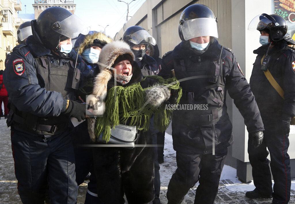 Uncredited Police detain a woman during a protest against the jailing of opposition leader Alexei Navalny in Siberian city of Omsk, Russia, Saturday, Jan. 23, 2021. Russian police on Saturday arrested hundreds of protesters who took to the streets in temperatures as low as minus-50 C (minus-58 F) to demand the release of Alexei Navalny, the country's top opposition figure. Navalny, President Vladimir Putin's most prominent foe, was arrested on Jan. 17 when he returned to Moscow from Germany, where he had spent five months recovering from a severe nerve-agent poisoning that he blames on the Kremlin. (AP Photo)