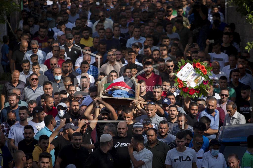Majdi Mohammed Palestinian mourners carry the body of Raed Jadallah, 39, who was killed by Israeli forces at the western entrance of his village while returning from work in the early hours of Wednesday morning, during his funeral, in the West Bank village of Beit Ur al-Tahta, Wednesday, Sep. 1, 2021. (AP Photo/Majdi Mohammed)