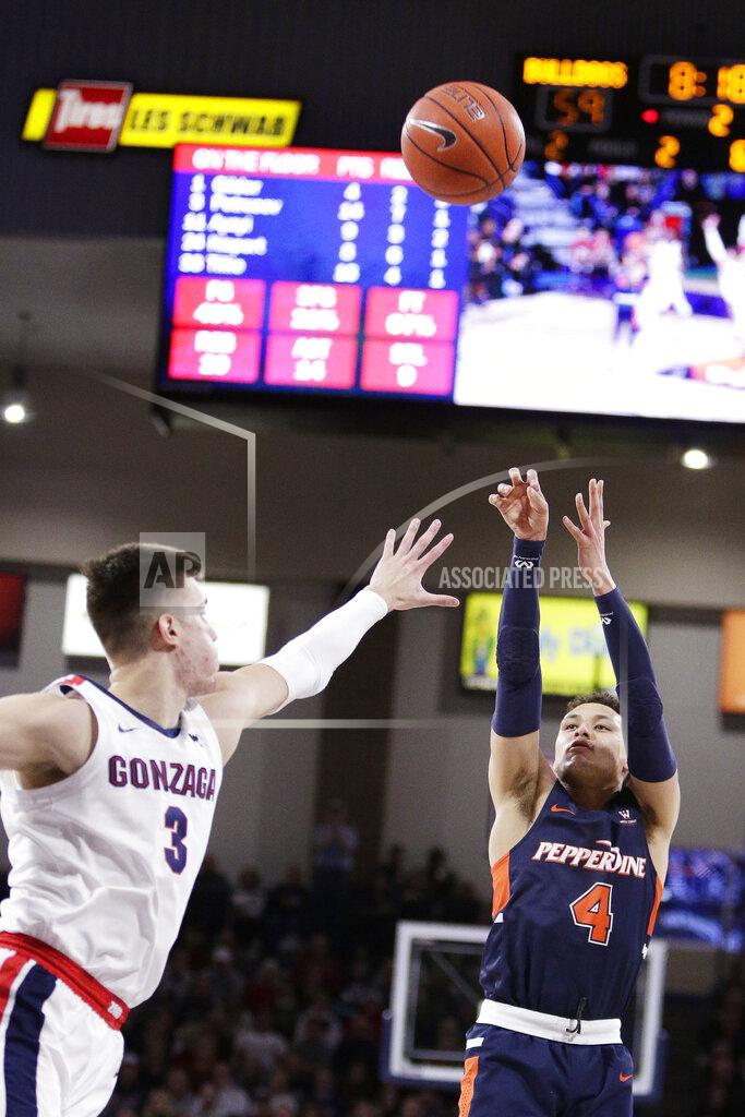 Young Kwak Pepperdine guard Colbey Ross (4) shoots over Gonzaga forward Filip Petrusev (3) during the second half of an NCAA college basketball game in Spokane, Wash., Saturday, Jan. 4, 2020. Gonzaga won 75-70. (AP Photo/Young Kwak)