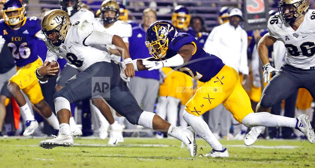 Karl B Deblaker Central Florida quarterback Darriel Mack Jr. (8) tries to get away from East Carolina's Devon Sutton (42) during the first half of an NCAA college football game in Greenville, N.C., Saturday, Oct. 20, 2018. (AP Photo/Karl B DeBlaker)