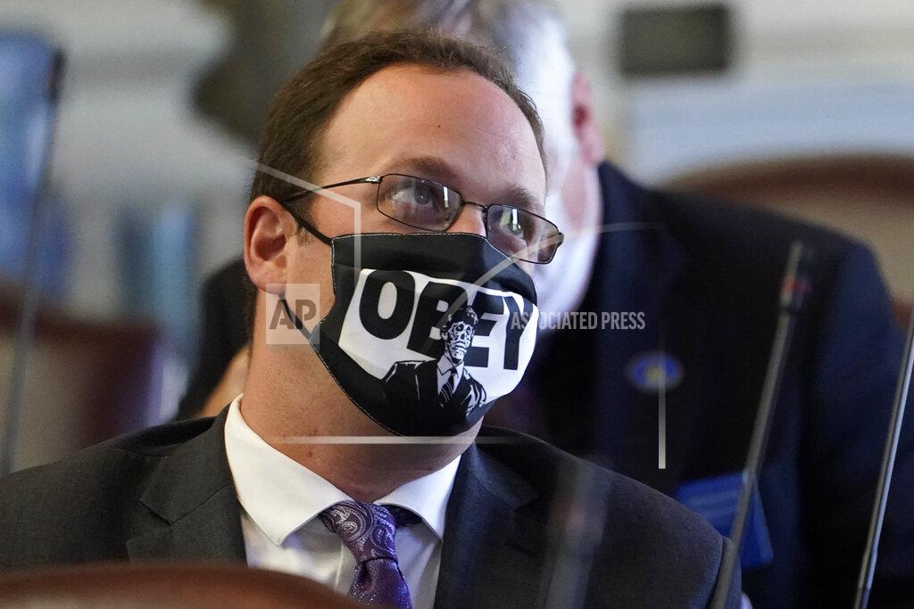 Robert F. Bukaty Rep. Joseph Fecteau, R-Augusta, wears a face covering during the first legislative session in the State House since the proceedings were moved to the more spacious Augusta Civic Center, Wednesday, June 2, 2021, in Augusta, Maine. (AP Photo/Robert F. Bukaty)