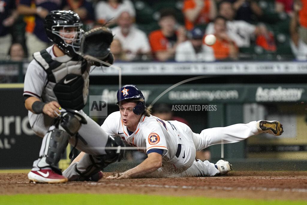 David J. Phillip Houston Astros' Jake Meyers, right, scores as Arizona Diamondbacks catcher Daulton Varsho reaches for the ball during the 10th inning of a baseball game Saturday, Sept. 18, 2021, in Houston. (AP Photo/David J. Phillip)