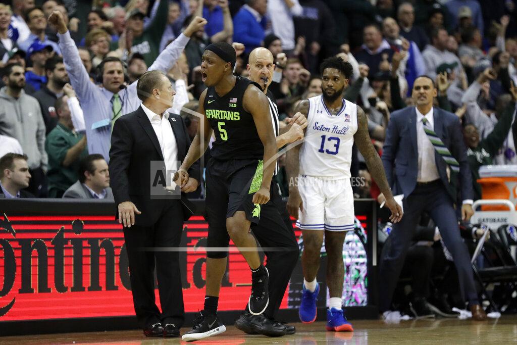 Adam Hunger Michigan State guard Cassius Winston (5) reacts after making a three-point basket in front of Seton Hall guard Myles Powell (13) during the second half of an NCAA college basketball game Thursday, Nov. 14, 2019, in Newark, N.J. (AP Photo/Adam Hunger)