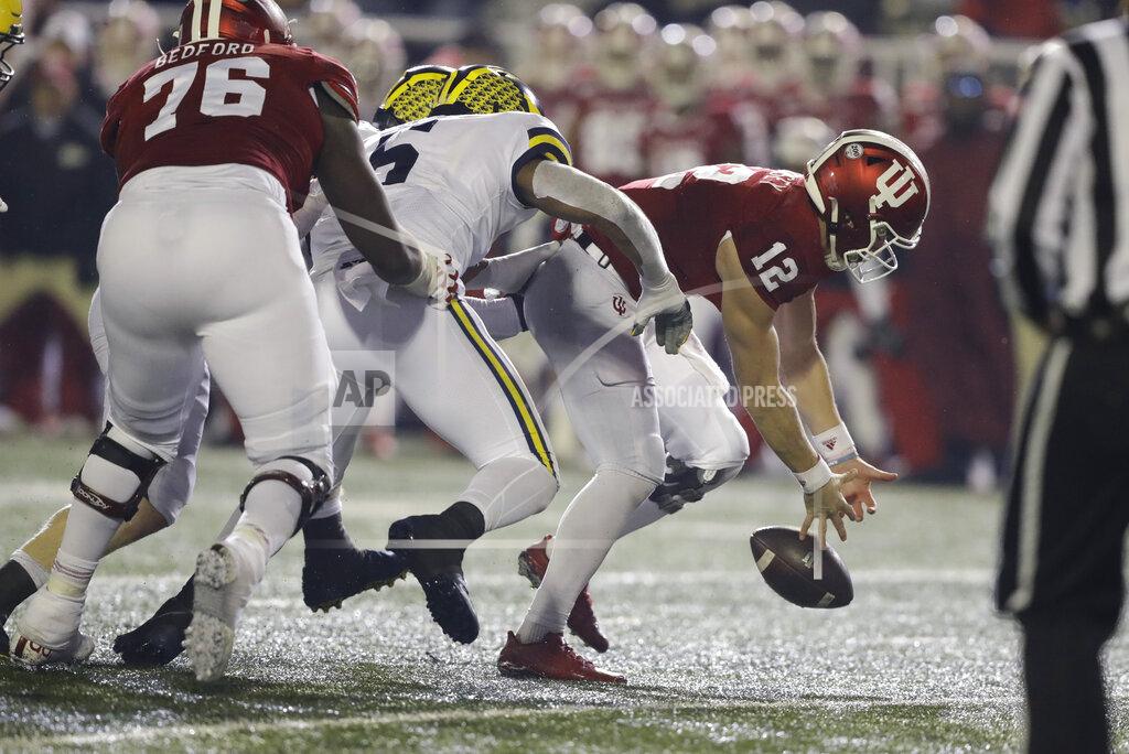 Darron Cummings Indiana quarterback Peyton Ramsey (12) tries to recover a fumble after being hit by Michigan linebacker Josh Uche (6) during the second half of an NCAA college football game, Saturday, Nov. 23, 2019, in Bloomington, Ind. Michigan won 39-14. (AP Photo/Darron Cummings)