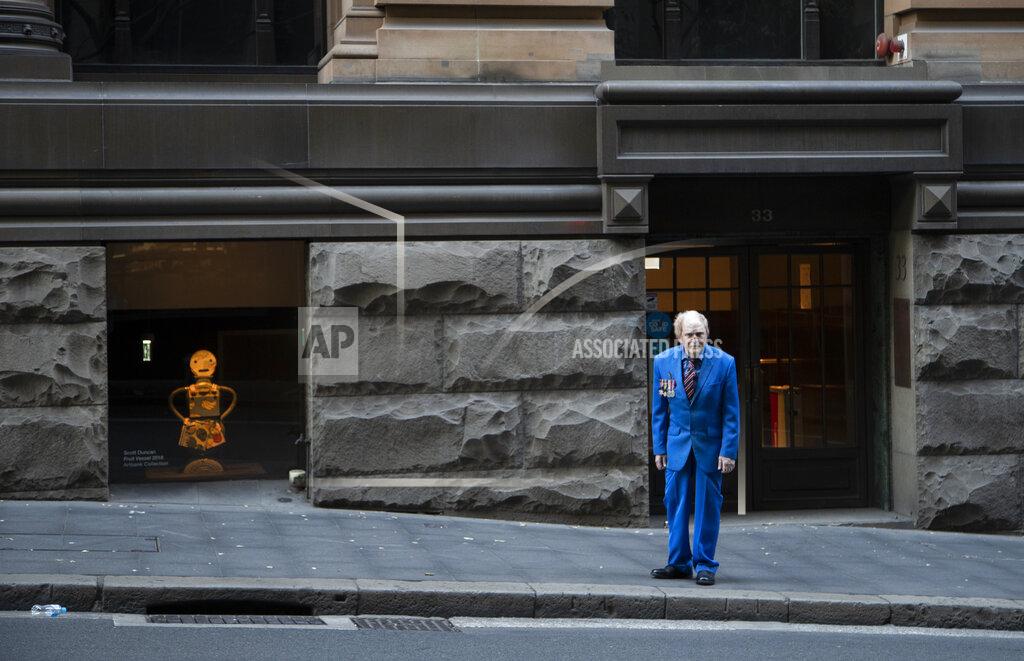 Mark Baker A veteran stands alone ahead of the Anzac Day parade in Sydney, Australia, Sunday, April 25, 2021. Australians and New Zealanders paid tribute to their war dead Sunday as both nations prepared to withdraw from their longest war in Afghanistan. (AP Photo/Mark Baker)