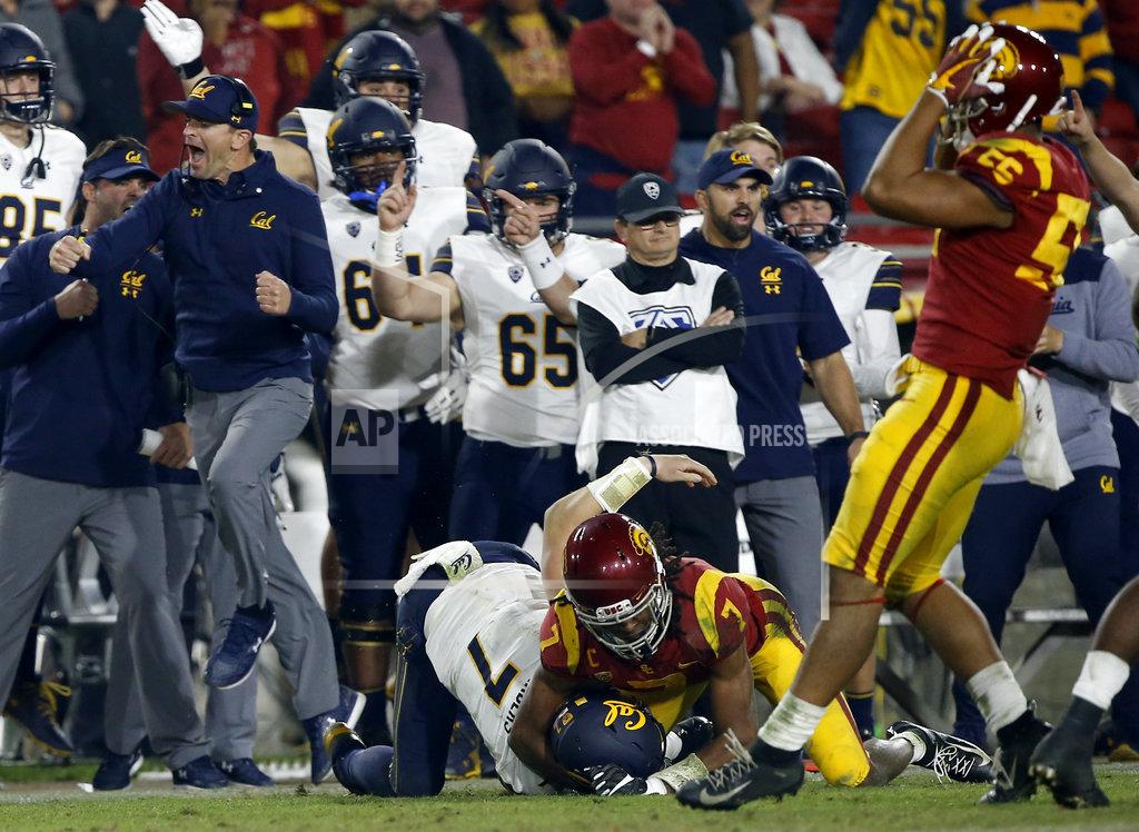 Alex Gallardo California head coach Justin Wilcox, left, leaps to celebrate a first down by quarterback Chase Garbers, center, by Southern California safety Marvell Tell III, second from right, as linebacker Jordan Iosefa, right, laments during the second half of an NCAA college football game in Los Angeles, Saturday, Nov. 10, 2018. California won 15-14. (AP Photo/Alex Gallardo)
