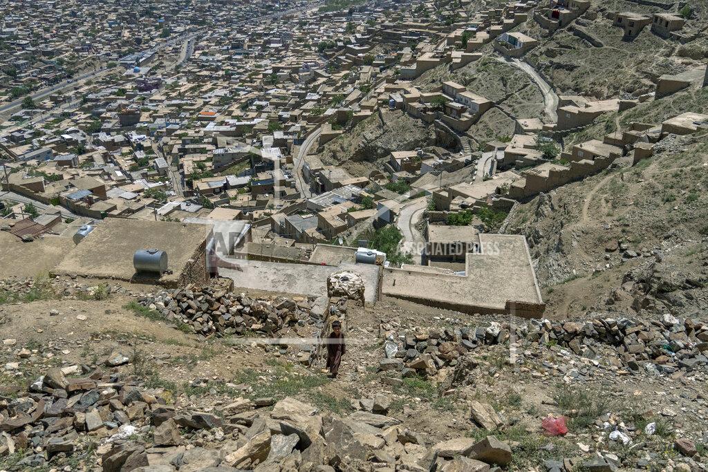 Ebrahim Noroozi An Afghan child walksnext to his home atop a hill in one of Kabul's poor neighbourhoods in Kabul, Afghanistan Saturday, May 21, 2022. Some 1.1 million Afghan children under the age of five will face malnutrition by the end of the year. , as hospitals wards are already packed with sick children . (AP Photo/Ebrahim Noroozi)