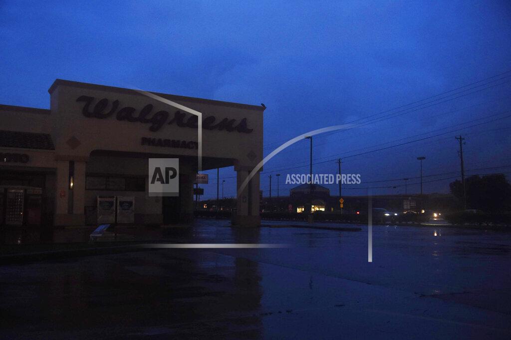 Annie Rice A darkened Walgreens is seen off of Saratoga and Staples during Hurricane Hanna, Saturday, July 25, 2020, in Corpus Christi, Texas. As of mid-Saturday, AEP Texas reports 16,564 power outages in Nueces County. (Annie Rice/Corpus Christi Caller-Times via AP)