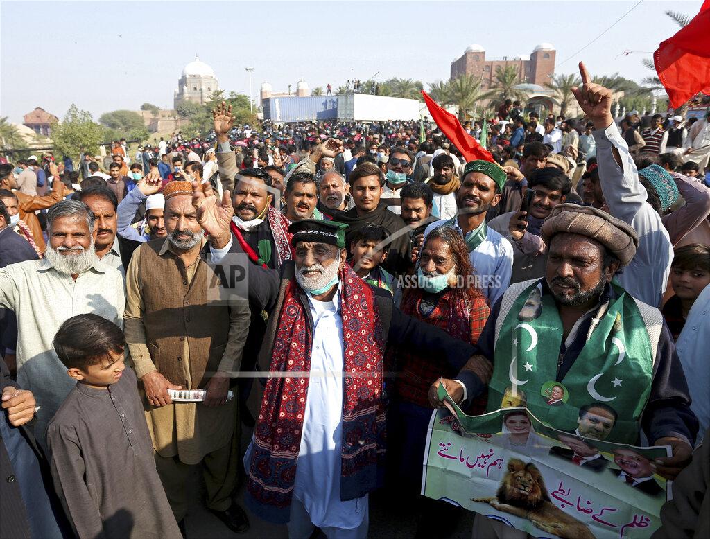 Asim Tanveer Supporters of the Pakistan Democratic Movement, an alliance of opposition parties, gather at a main intersection before an anti-government rally in Multan, Pakistan, Monday, Nov. 30, 2020. Pakistani police arrested hundreds of supporters of opposition parties ahead of a planned rally Monday calling for the country's prime minister to resign, a move the government defended as necessary to combat the coronavirus pandemic. (AP Photo/Asim Tanveer)