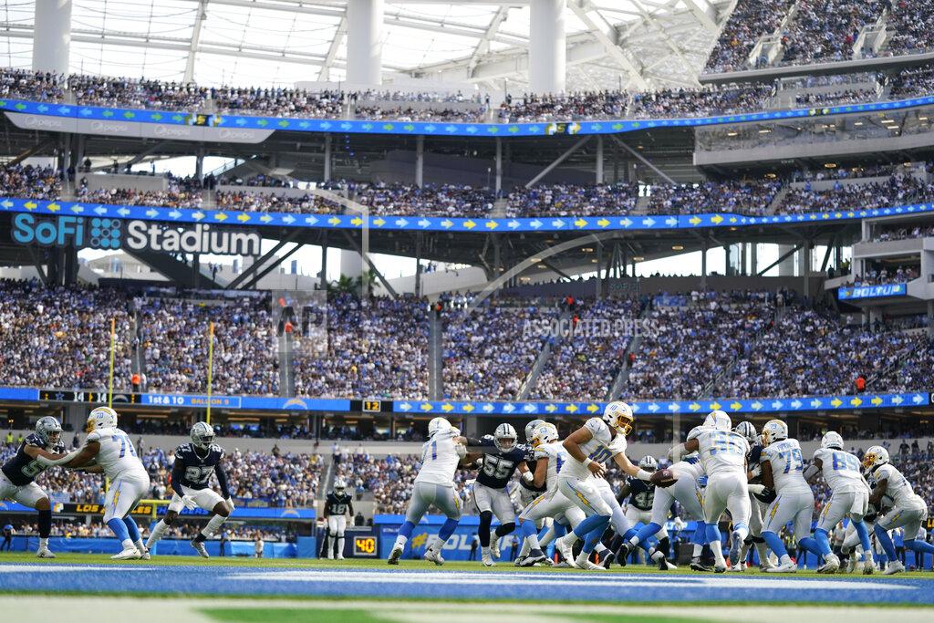 Ashley Landis Los Angeles Chargers quarterback Justin Herbert hands off to running back Austin Ekeler (30) during the second half of an NFL football game Sunday, Sept. 19, 2021, in Inglewood, Calif. (AP Photo/Ashley Landis)