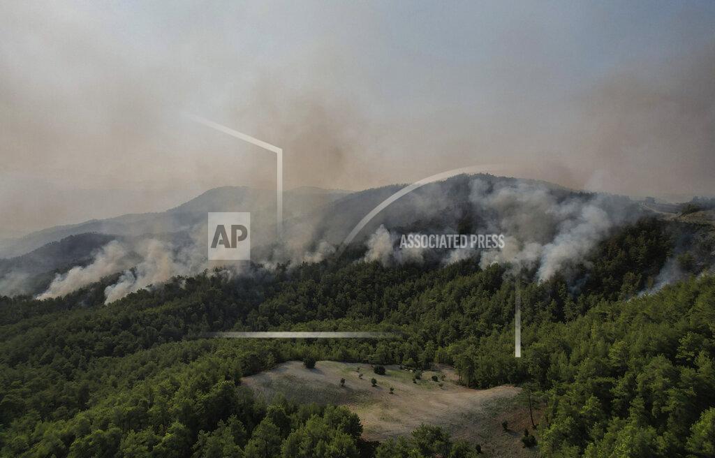 Uncredited Wildfires continue to rage the forests in Manavgat, Antalya, Turkey, early Sunday, Aug. 1, 2021. The fires in Antalya were continuing overnight in Manavgat and Gundogmus districts. In Bodrum, Mugla, they continued to burn down forests, encroaching on villages and tourist destinations and forcing people to evacuate by boats. (AP Photo)