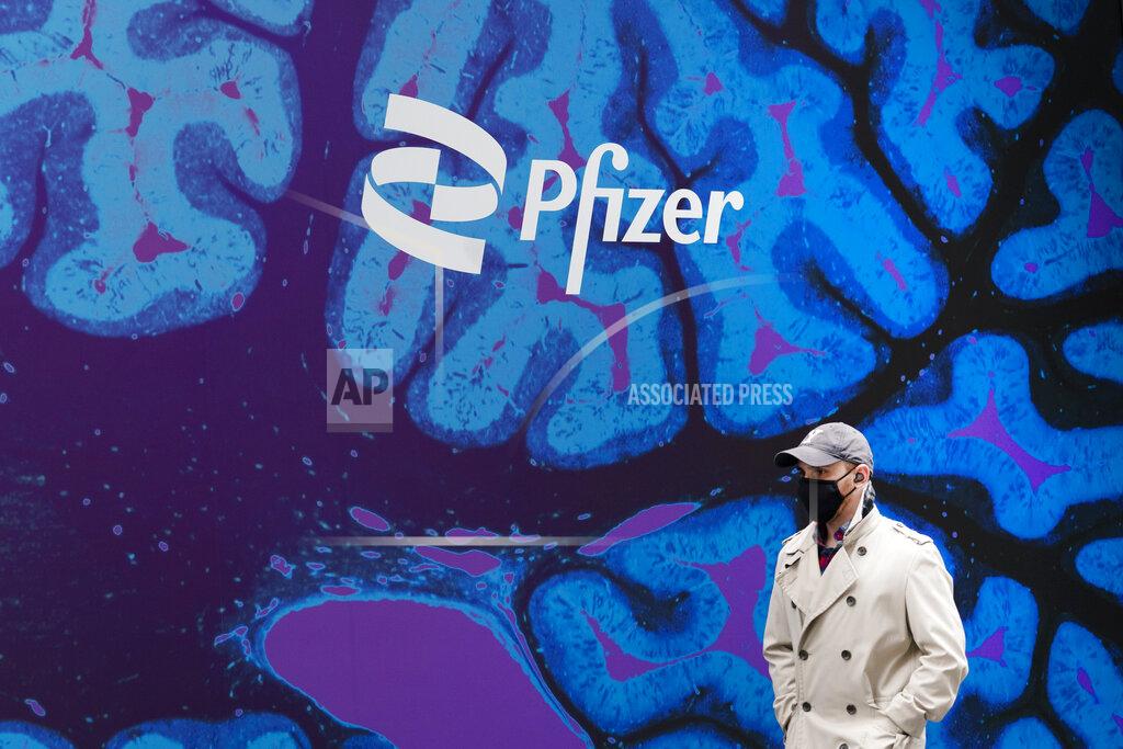 Mark Lennihan A man walks by Pfizer headquarters, Friday, Feb. 5, 2021 in New York. Pfizer, buoyed by a huge jump in sales for its COVID-19 vaccine and solid first-quarter performance across most of the company, hiked its 2021 financial forecast after sharply after blowing past Wall Street expectations, Tuesday, May 4. (AP Photo/Mark Lennihan)