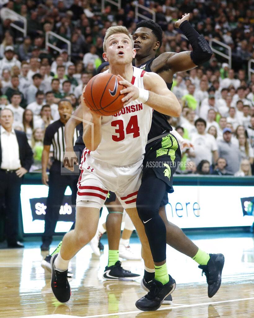 Carlos Osorio Wisconsin guard Brad Davison (34), defended by Michigan State guard Rocket Watts, attempts a layup during the first half of an NCAA college basketball game, Friday, Jan. 17, 2020, in East Lansing, Mich. (AP Photo/Carlos Osorio)
